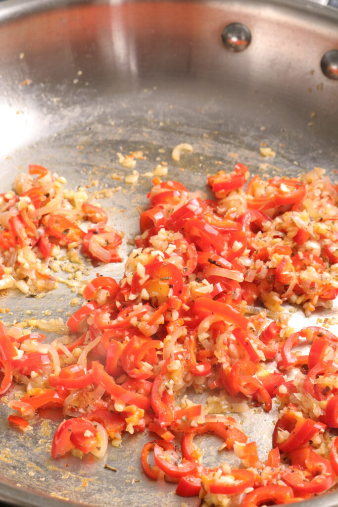 shallots, garlic and red chilli sautéing in a frying pan