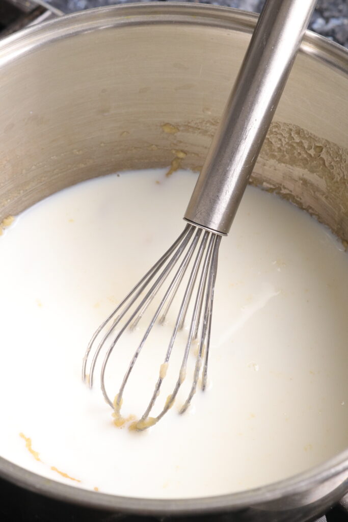 milk and a whisk in a saucepan