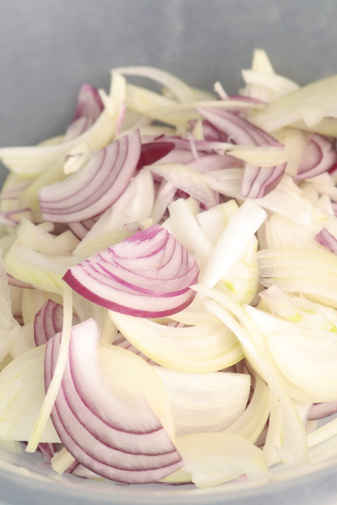 red and white onions in a mixing bowl