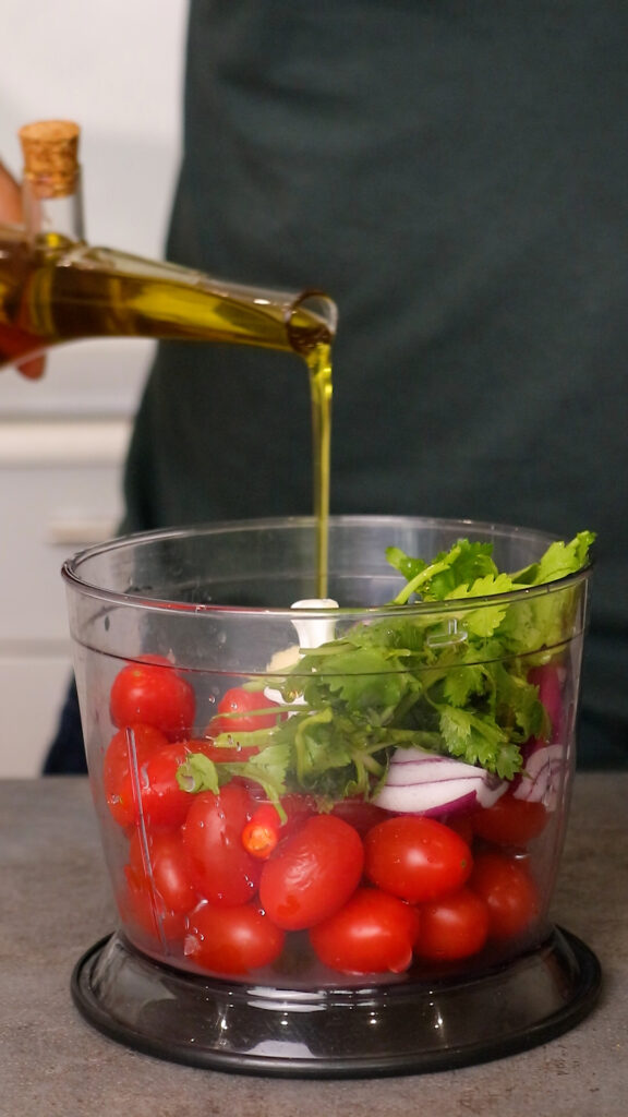 salsa ingredients placed in a food processor