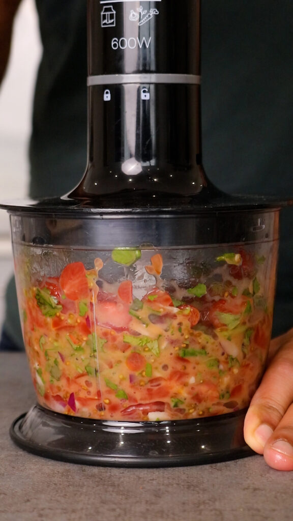 salsa ingredients placed in a food processor