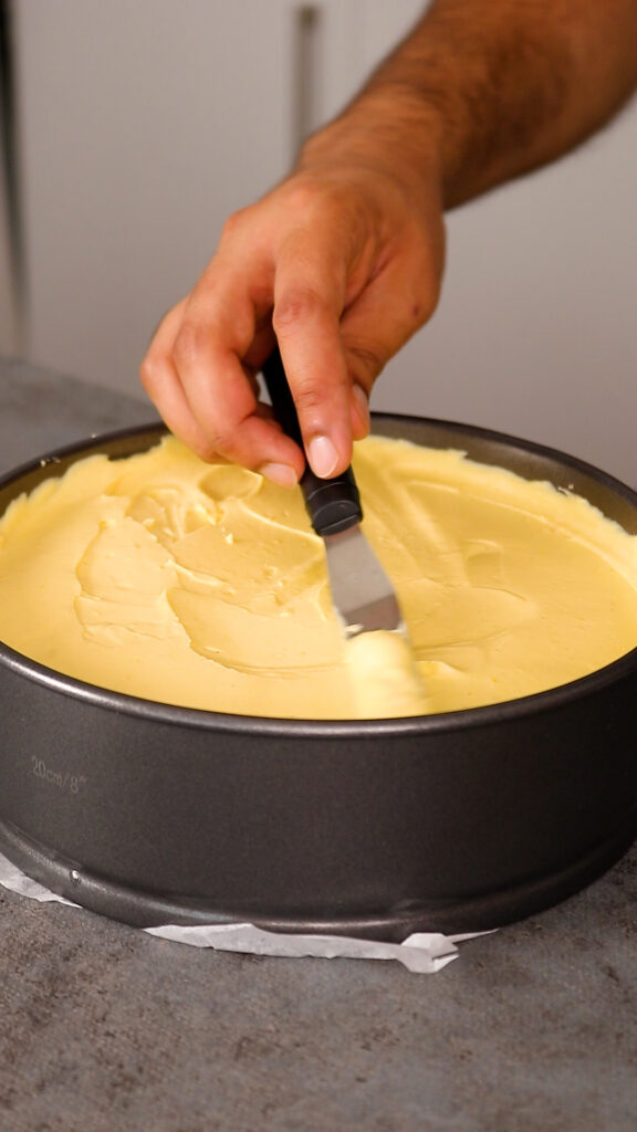 smoothing over cheesecake filling with a spatula