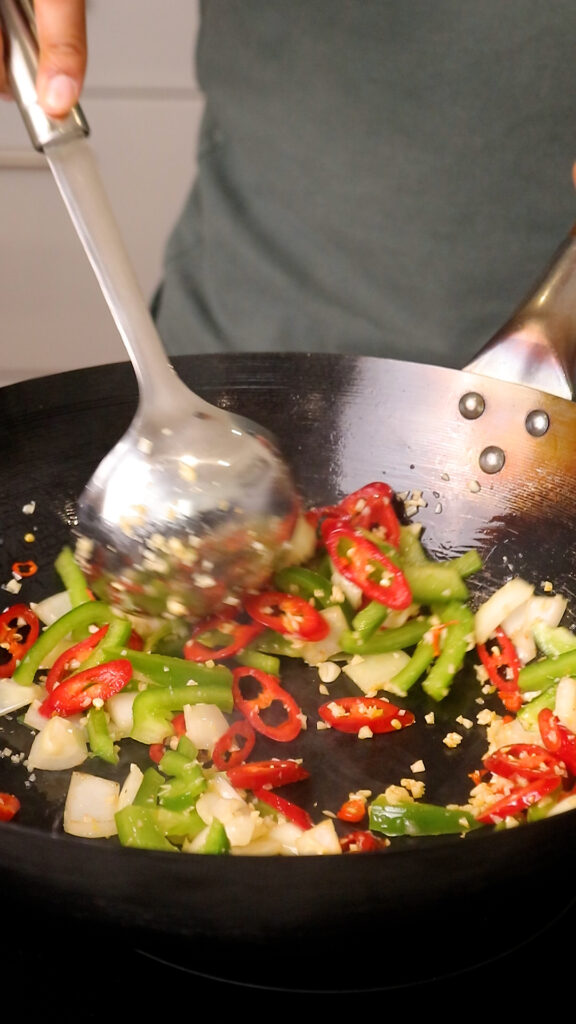 sauté onion, garlic, red chillies, and green pepper