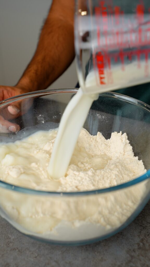 pouring liquid mixture into flour mixture
