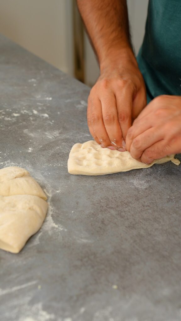 stretching out naan dough