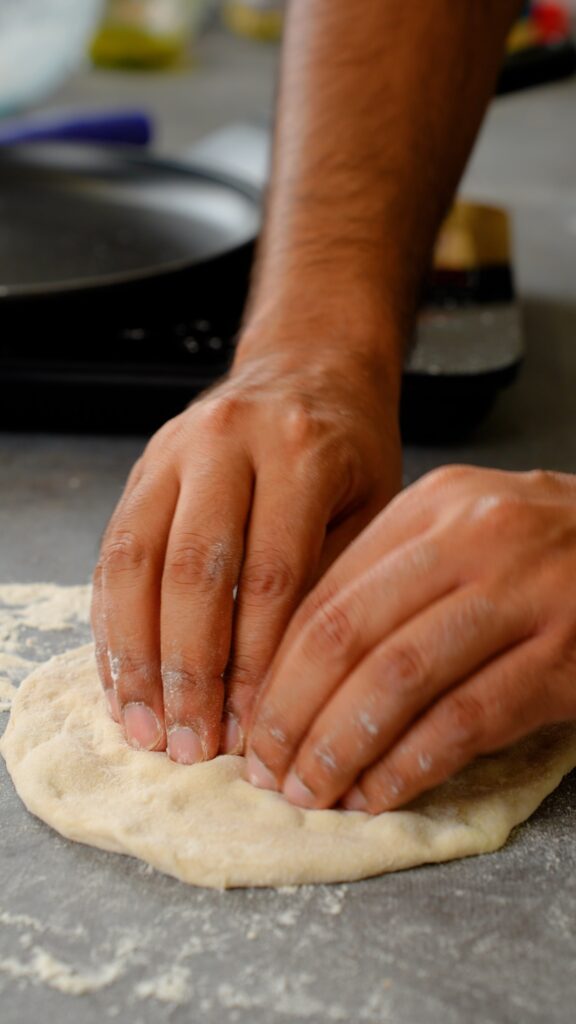 stretching out naan dough