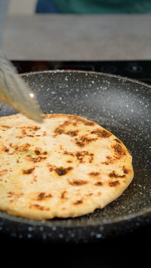 cooking naan in a pan