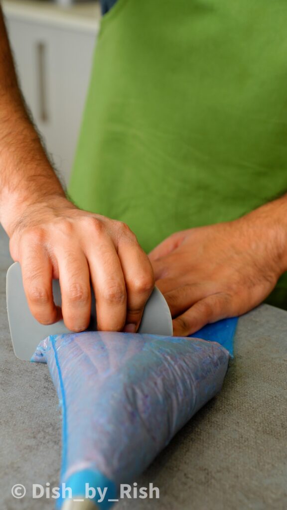 placing strawberry Viennese whirls dough into a piping bag