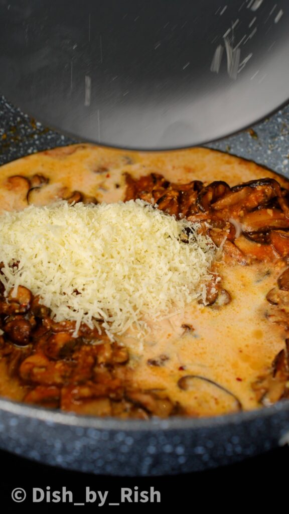 adding grated cheese to chilli miso mushroom