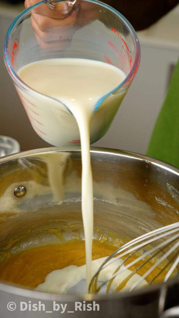 pouring milk into the roux