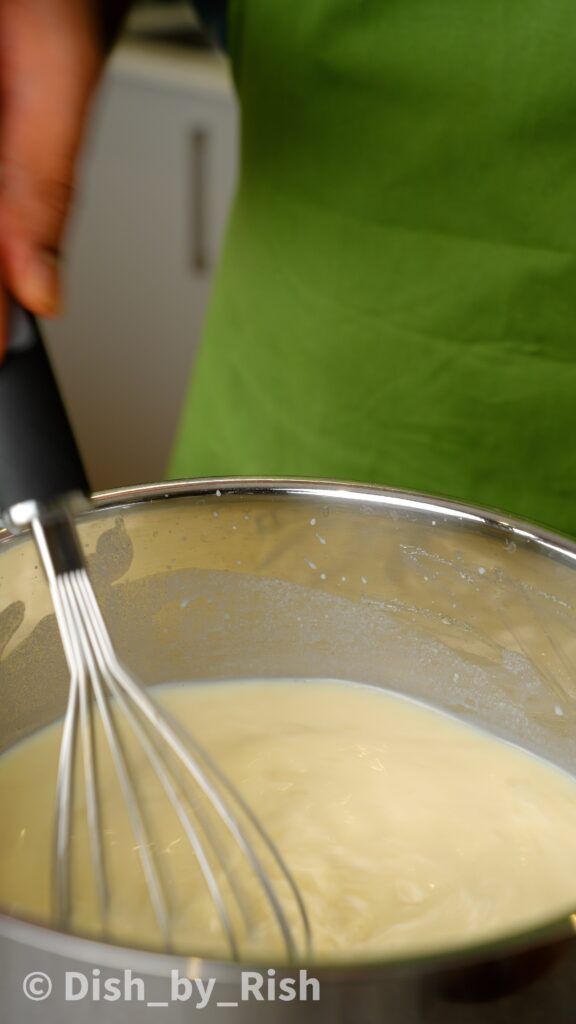 whisking béchamel sauce