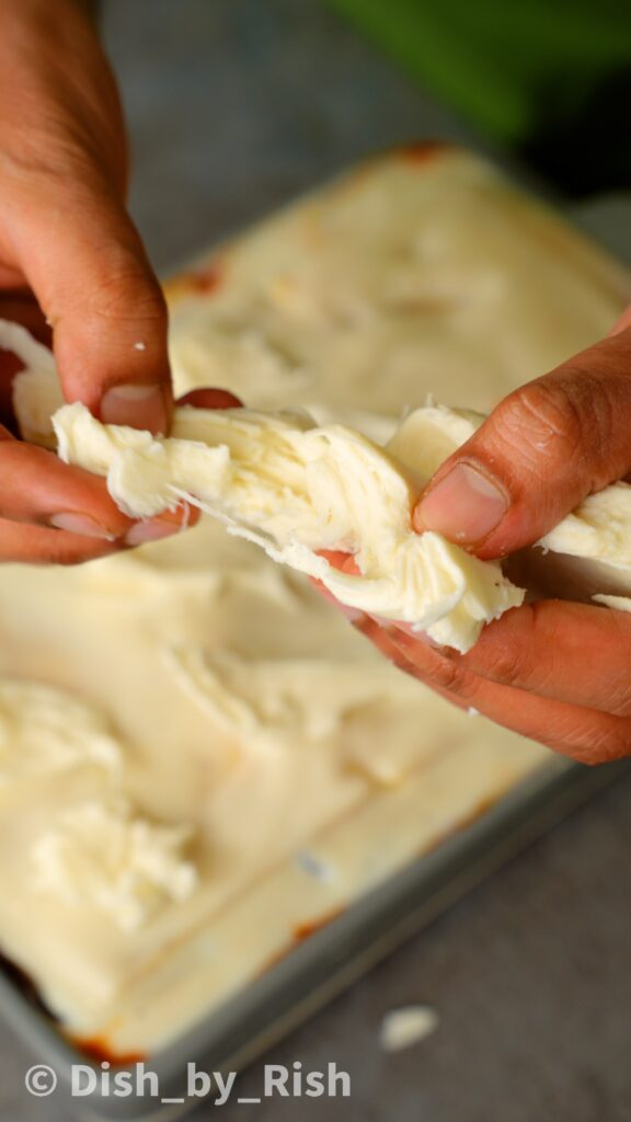 finishing the roasted aubergine and arrabbiata lasagne with fresh mozzarella