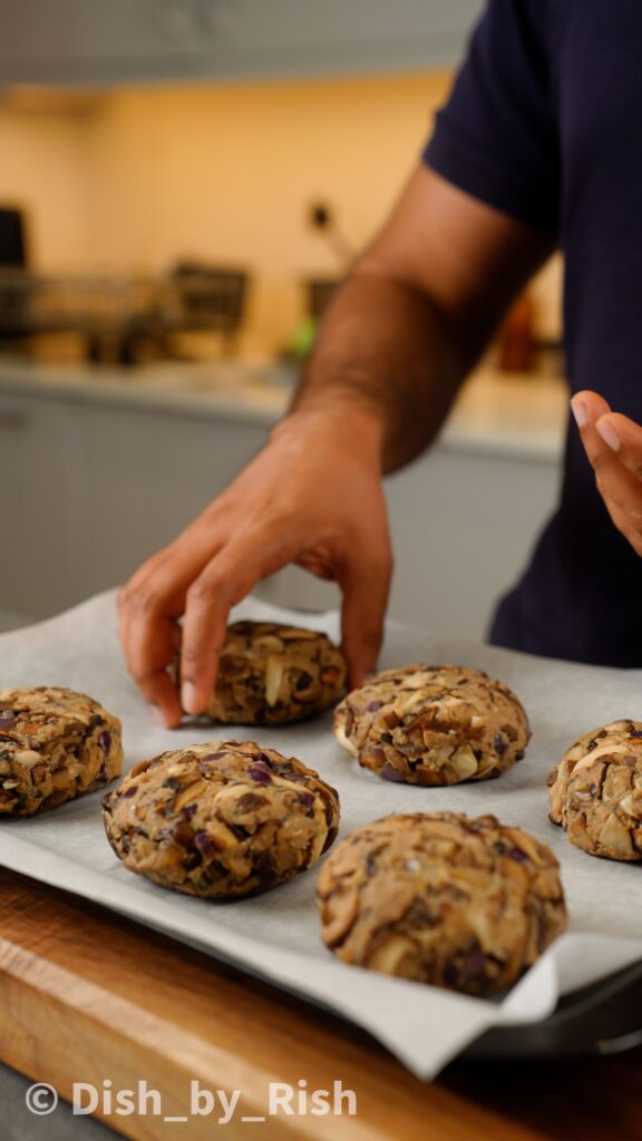 placing mushroom burger patty on a baking tray