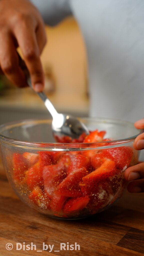 mix strawberries with orange zest and sugar