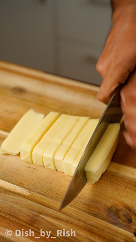 cutting low moisture mozzarella into sticks