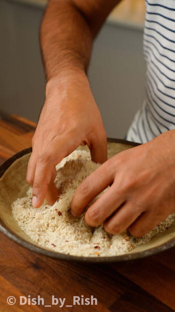 coating mozzarella stick in panko breadcrumbs