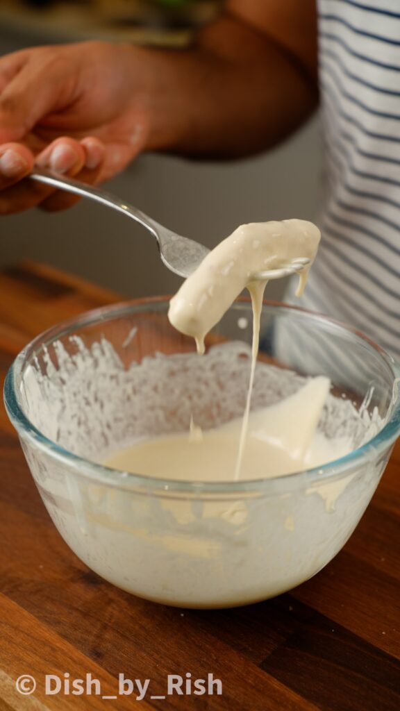 second dunk of mozzarella into flour paste