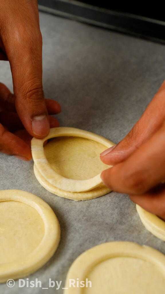 placing ring of puff pastry on to disc of puff pastry