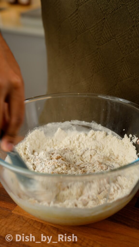 adding in dry ingredients to mixing bowl