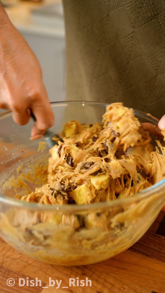 folding in barfi and chocolate chips into cookie dough