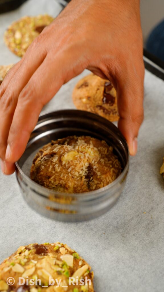 using cookie cutter to help tidy up edges of cookies