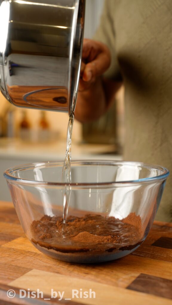 pouring hot oil over cocoa powder