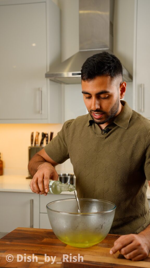 pouring vinegar into egg whites