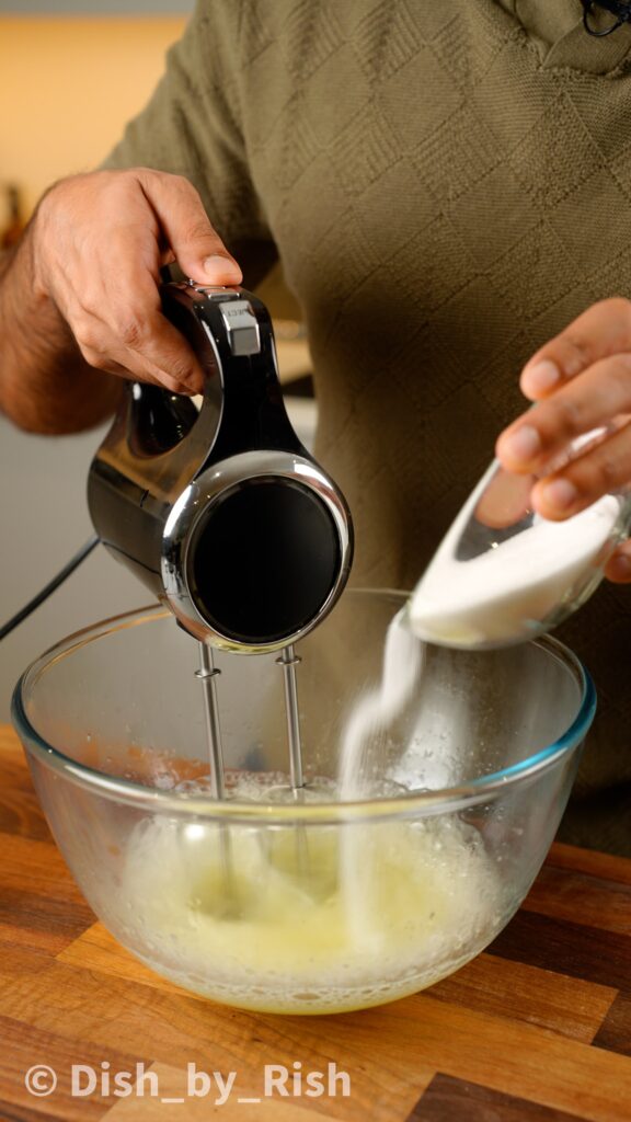 whisking egg whites and gradually adding sugar