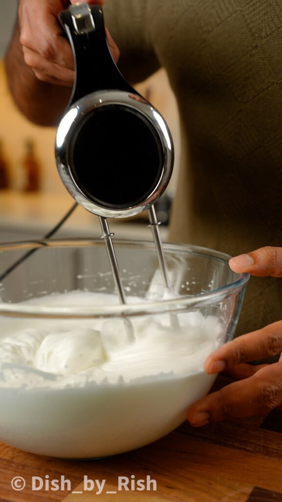 whisking egg whites and gradually adding sugar