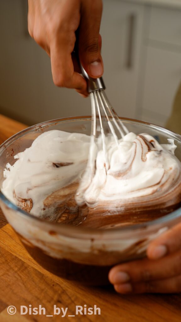 folding egg whites into chocolate yolk mixture