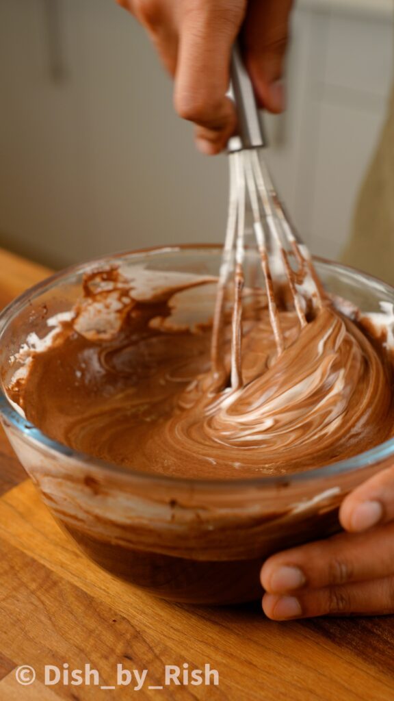 folding egg whites into chocolate yolk mixture