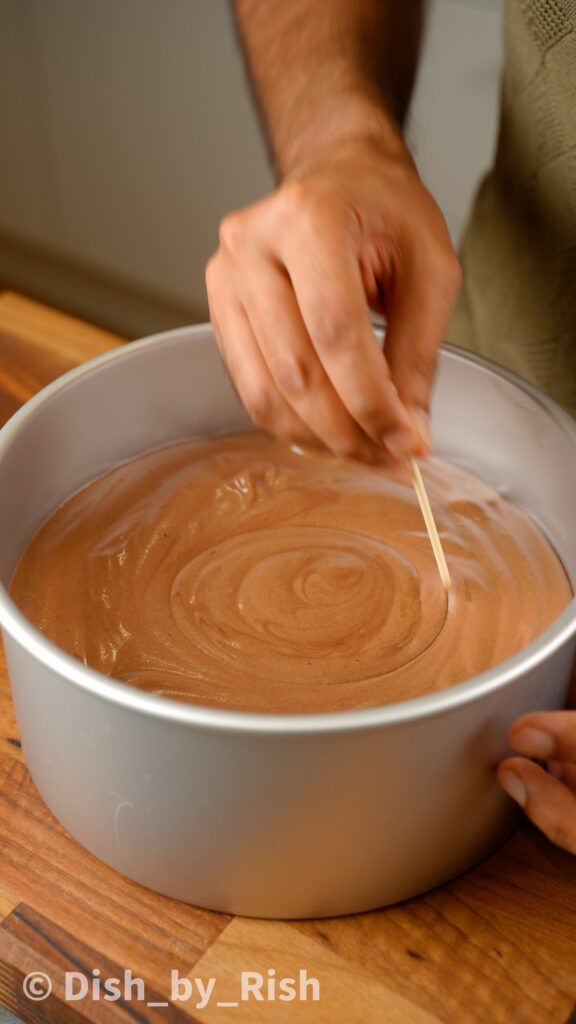 using a skewer to swirl around the cake mixture