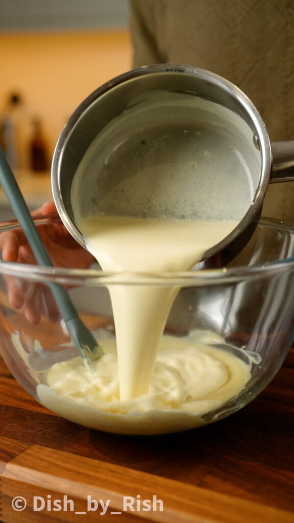 pouring warm cream over white chocolate