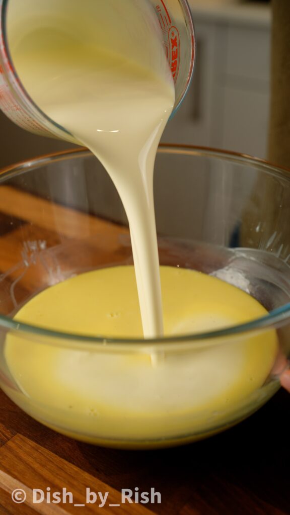 pouring cold cream over white chocolate and cream mixture