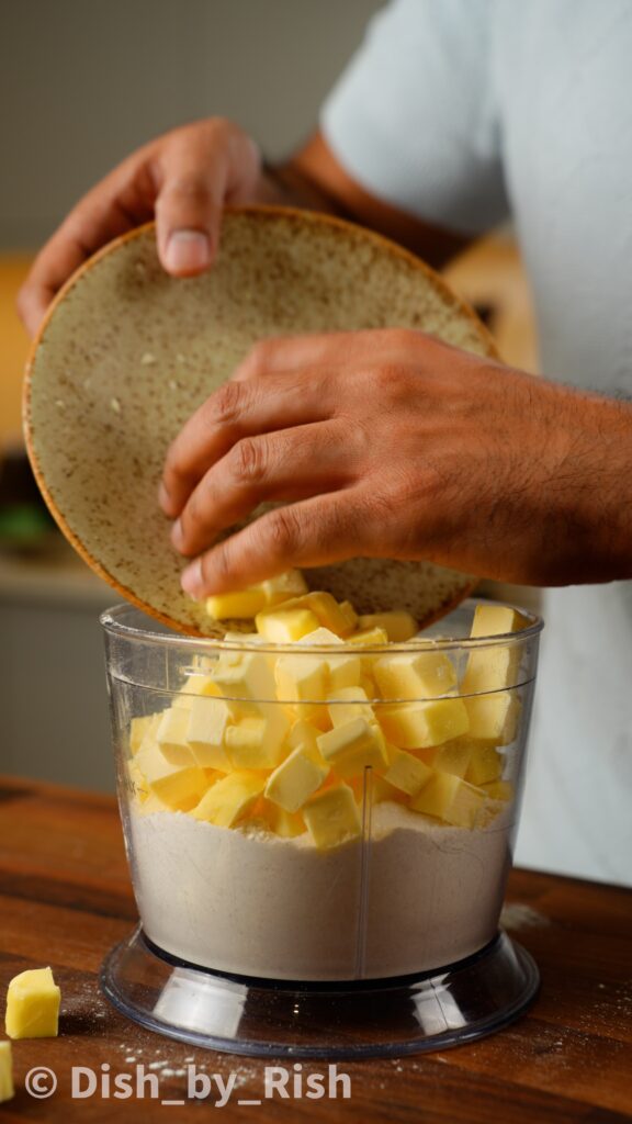 flour, sugar, salt, and frozen butter in a food processor