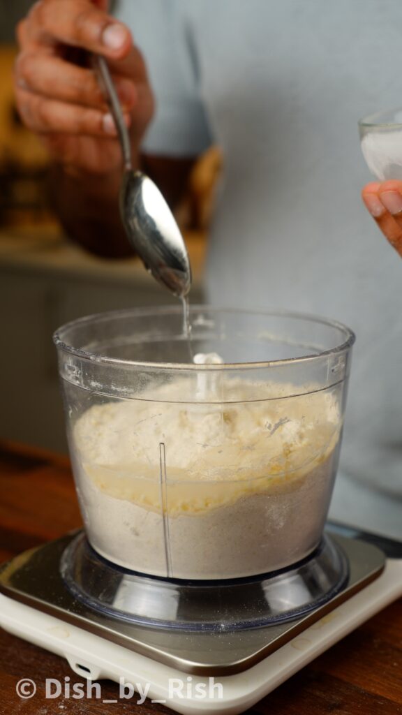 adding ice cold water to food processor