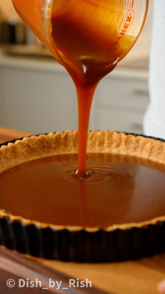 pouring caramel into pastry base