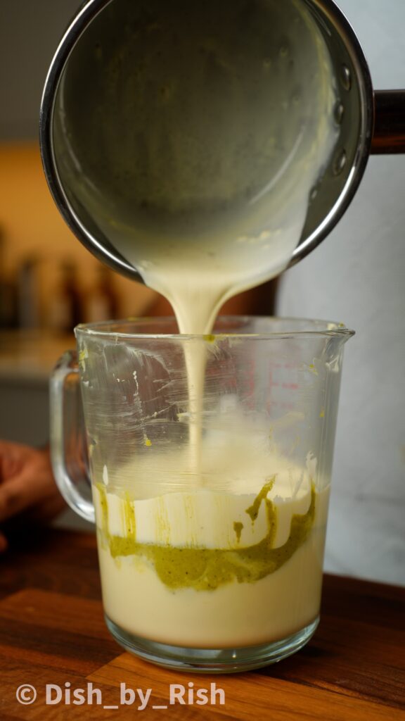 warm cream being poured over white chocolate and pistachio butter