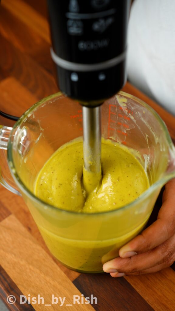 pistachio ganache being blended with an immersion blender