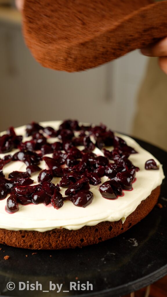 top whipped cream with Kirsch soaked cherries