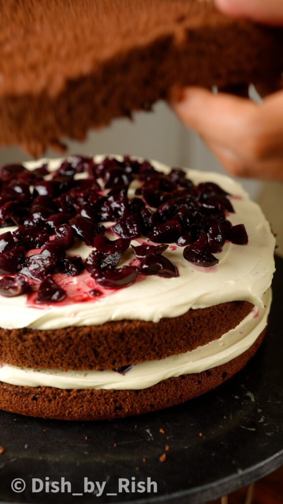 top whipped cream with Kirsch soaked cherries