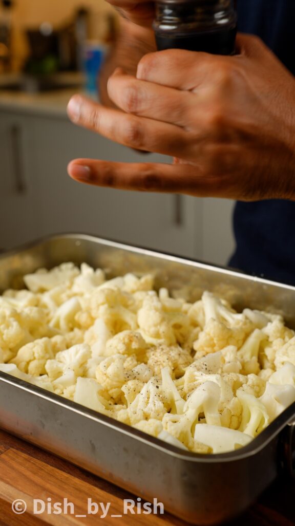 cauliflower florets, olive oil, salt, and pepper in a roasting tray