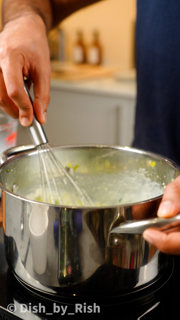 whisking béchamel sauce