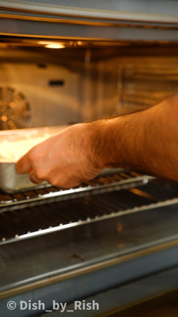 placing truffle and brie cauliflower cheese into the oven