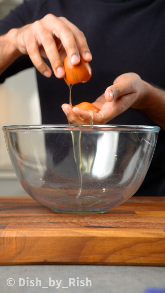 separating eggs in hands over a bowl