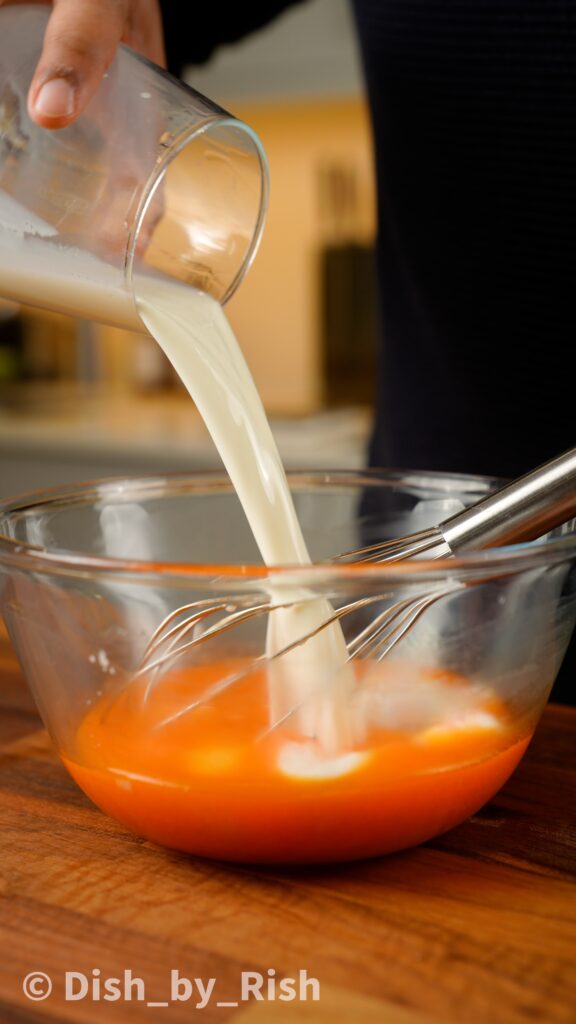 adding milk to egg yolks and oil