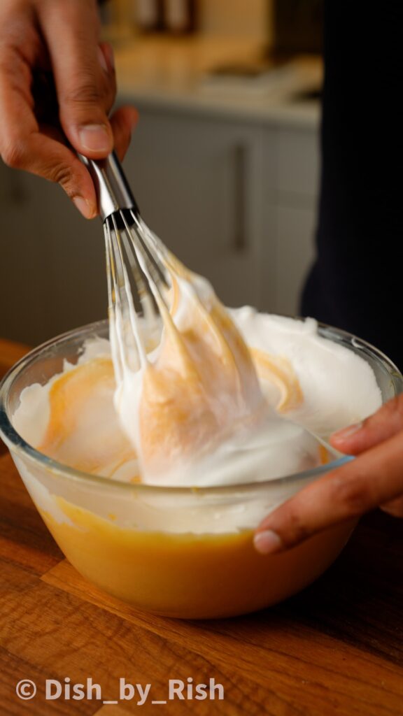 folding egg white mixture into yolk mixture