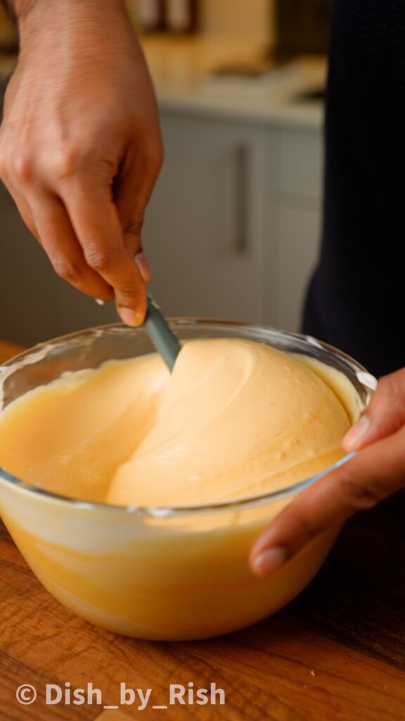 folding egg white mixture into yolk mixture