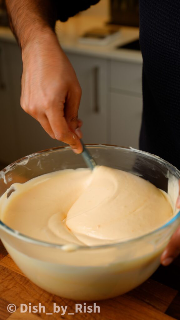 folding lightened egg yolk batter with remaining egg whites