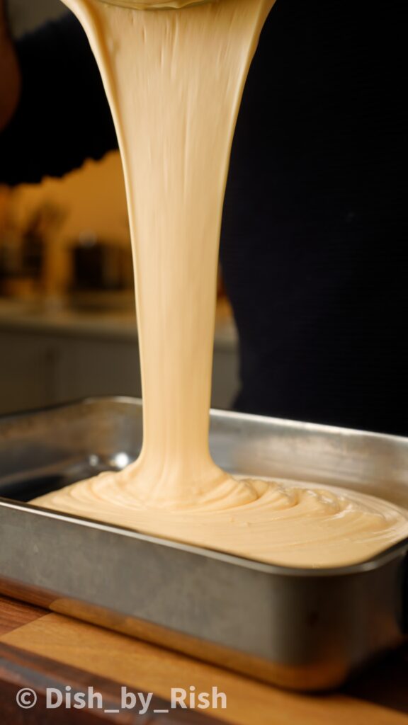 pouring chiffon cake batter into tin from a height